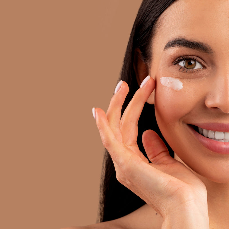 Girl Applying Cream On Face