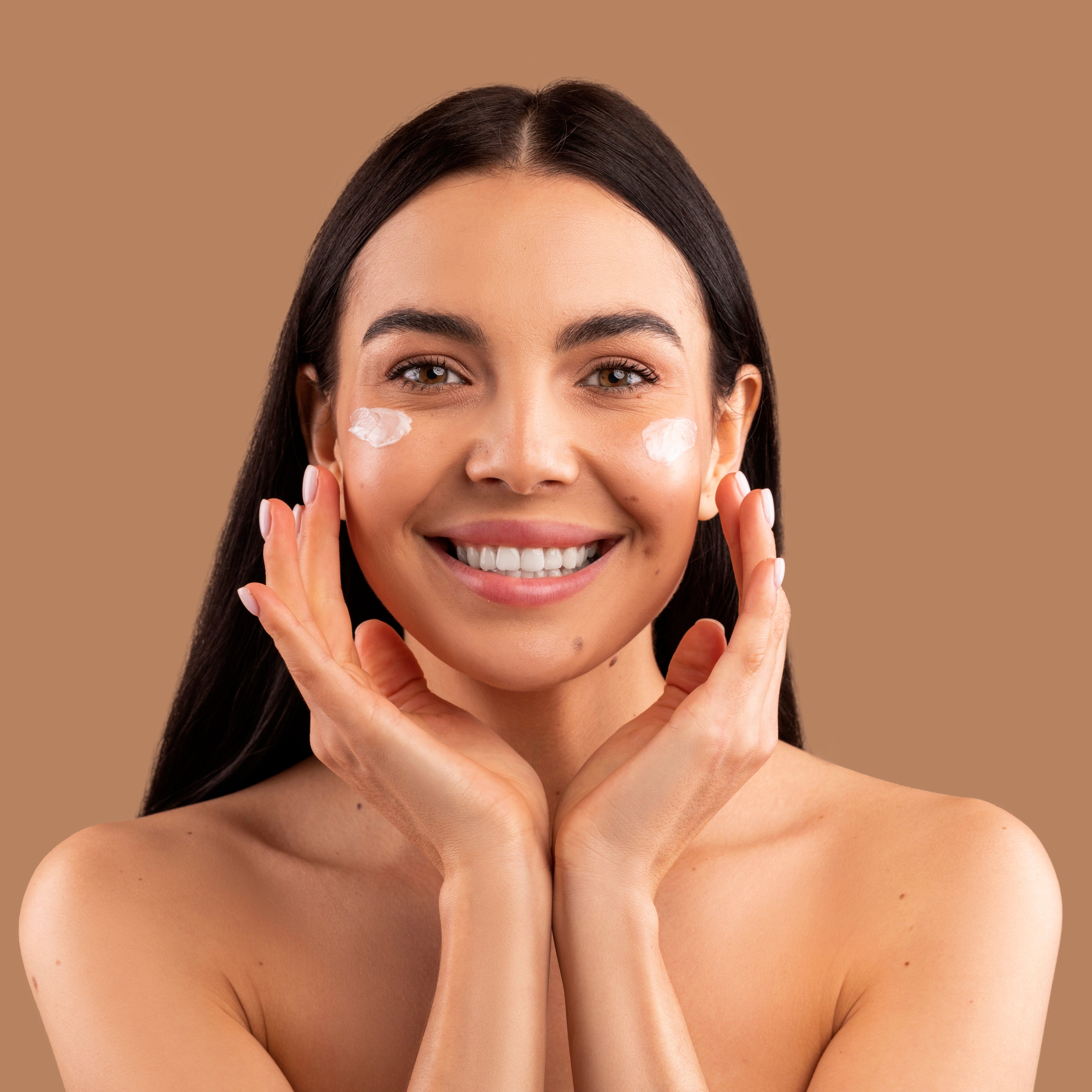 Woman Applying Cream On Face